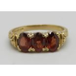 A 9ct gold ring set with garnets, 2.2g, L