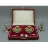 A pair of silver salts with spoons, cased, and a silver salt and pepper pair, 86g
