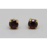 A pair of 9ct gold and red stone earrings, 0.8g