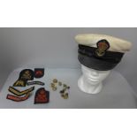 A sailor's peaked cap, buttons and uniform cloth badges