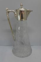 A cut glass claret jug with silver plated top
