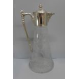 A cut glass claret jug with silver plated top