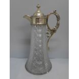 A claret jug with silver plated top