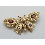 A 9ct gold, garnet and seed pearl butterfly brooch, 5g, 35mm