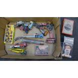 A box of die-cast model vehicles, jigsaw puzzles and a dominoes set