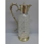 A cut glass claret jug with silver plated top