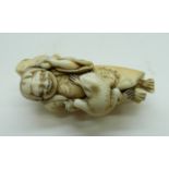 An ivory netsuke depicting a woman and two frogs, a/f, two small chips