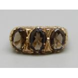 A 9ct gold trilogy ring set with smoky quartz, 3g, L