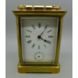 A four glass sided brass carriage clock with alarm and key