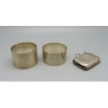A silver vesta case, Birmingham 1899, and two silver napkin rings including one George Unite, 66g