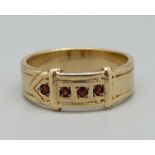 A 1970's 9ct gold and garnet buckle ring, Birmingham 1977, 6.2g, W