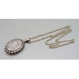 A Victorian silver locket on a silver chain, locket hallmarked Birmingham 1881