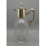 A small cut glass jug with silver plated top