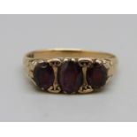 A 9ct gold and three garnet ring, 2.6g, O