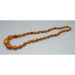 An amber coloured bead necklace