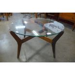 A teak and glass topped circular coffee table