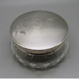 A silver topped glass pot with floral decoration, mirror inside the lid, 9cm diameter