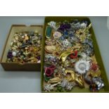 A collection of brooches and clip-on earrings