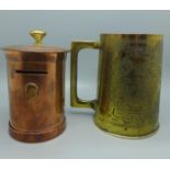 A WWII North Africa campaign brass tankard and a copper trench art money bank in the form of a