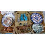 Three boxes containing oriental and Middle Eastern items, including plates, wooden figures, dogs