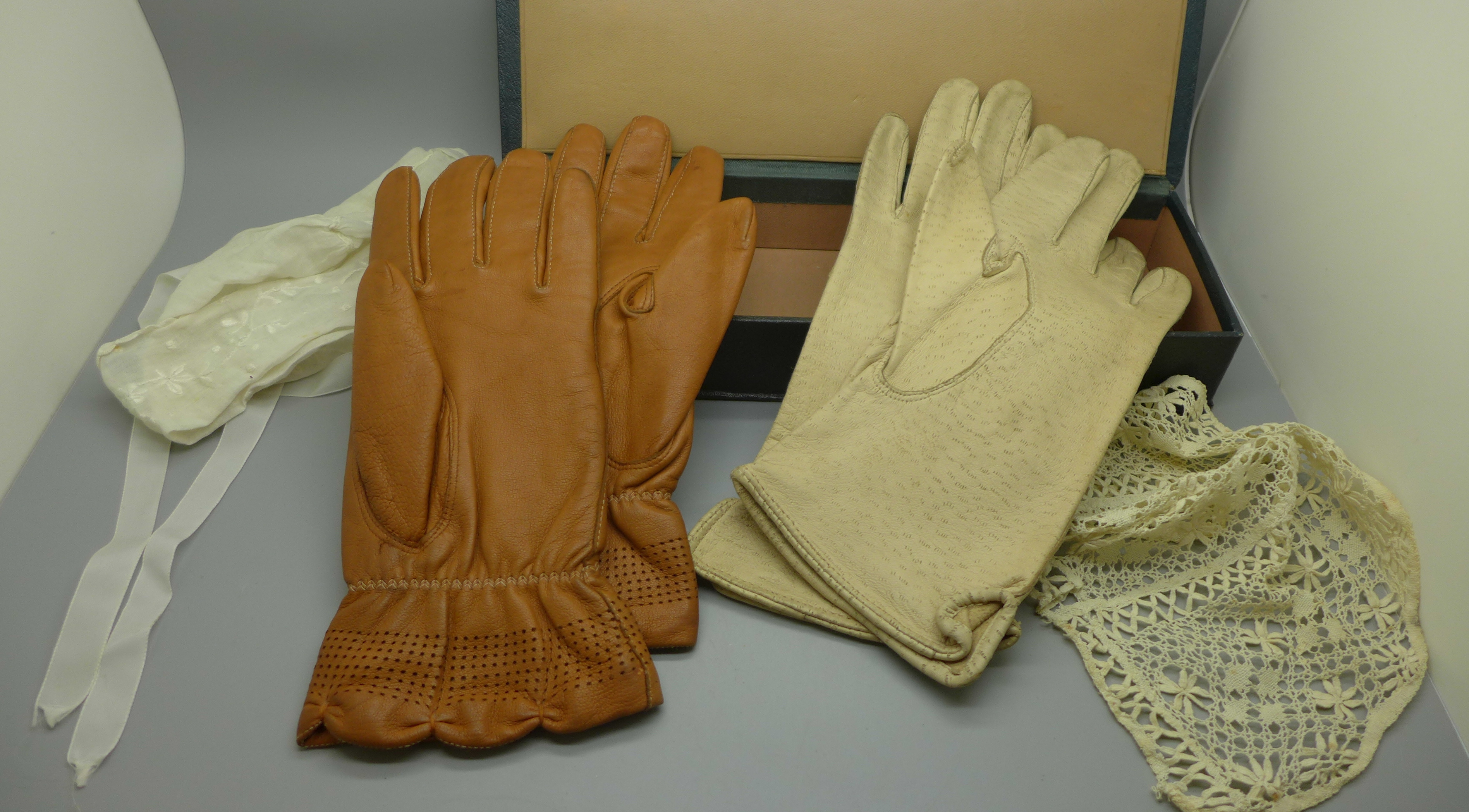 A glove box, two pairs of kid leather gloves and two Victorian baby bonnets