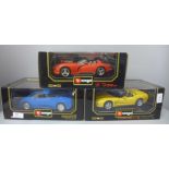 Three Burago 1:18 scale die-cast model vehicles, Dodge Viper, Chevrolet Corvette and Bugatti, boxed