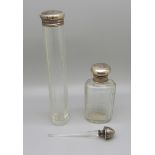 Two silver topped glass jars and a silver topped glass perfume dabber