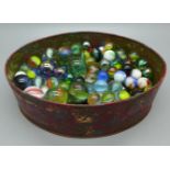 A tin of approximately 140 early to mid 20th Century marbles