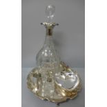 A glass decanter with silver top, an Elkington plate salver, a silver plated model of a cat, a small