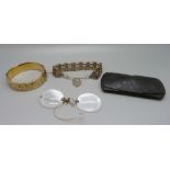 A rolled gold bangle, a gate bracelet and a pair of spectacles