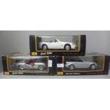 Three Maisto 1:18 scale die-cast model vehicles, Mercedes x2 and Porsche Boxster, boxed