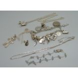 A silver charm bracelet, etc., 56g