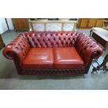 A red leather Chesterfield settee