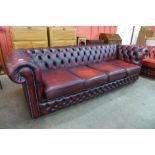 A red leather Chesterfield settee