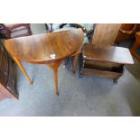 An oak magazine rack and a walnut demi-lune hall table