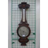 An Art Nouveau oak aneroid barometer, the silvered dial signed Gray & Selby, Nottingham