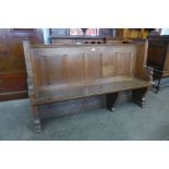 A Victorian carved oak church pew