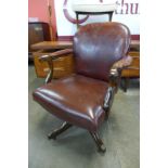 A Victorian mahogany and burgundy leather revolving desk chair