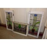 A pair of Art Nouveau stained glass windows and an Art Deco stained glass window