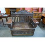 An early 20th Century Jacobean Revival carved oak settle