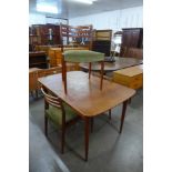 An Austin Suite teak extending dining table and four chairs