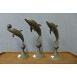 Three brass dolphin ornaments