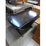 A dark oak drop-leaf kitchen table