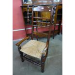 A George III style oak rush seated lambing chair
