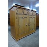 An oak geometric moulded cupboard