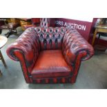 A red leather Chesterfield club chair