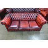 A red leather Chesterfield settee