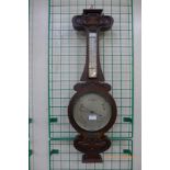 An Art Nouveau oak aneroid barometer, the silvered dial signed Gray & Selby, Nottingham