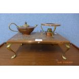 A copper plate on four brass legs with burner and a small copper and brass teapot marked W A S