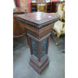 A carved oak pedestal